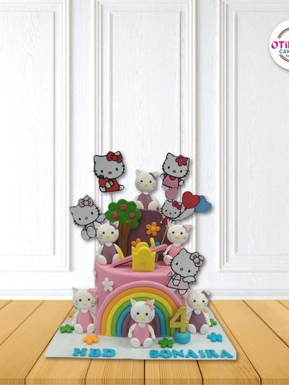 Hello Kitty fans will love this two-tiered pink cake. It's decorated with a rainbow, a seesaw, and lots of Hello Kitty figures, making it a playground of fun for a fourth birthday.
