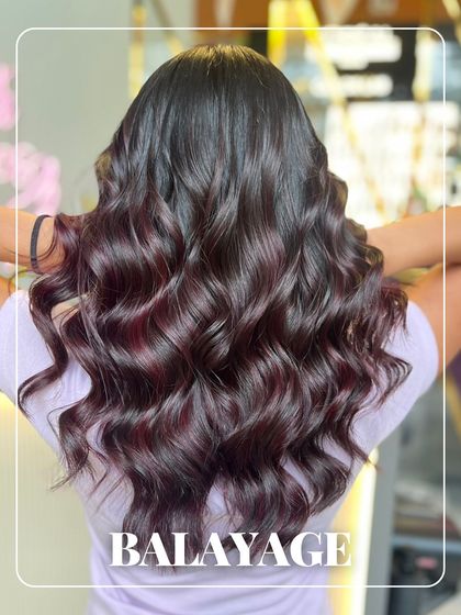 A deep and dimensional balayage with hints of rich violet. This hand-painted technique ensures the colour melts seamlessly from the natural root, creating a sophisticated and low-maintenance look.