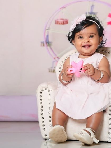 A happy customer in our candy land. The miniature armchair is the perfect size for our littlest clients.