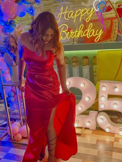 A closer look at the custom red satin birthday gown. The fabric drapes beautifully, and the strapless neckline is classic and elegant.