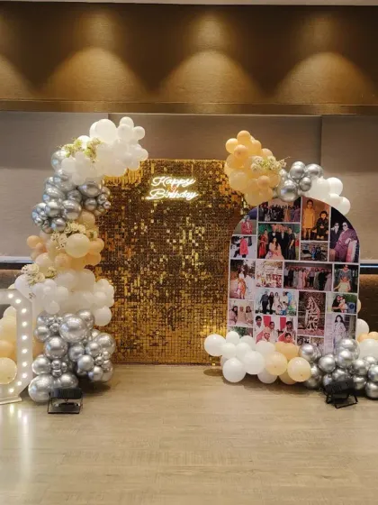 For this special 60th birthday, I designed a personalized backdrop featuring a collage of cherished family photos. The setup is complemented by a gold sequin wall, marquee light-up numbers, and an elegant balloon garland in white, silver, and peach tones.