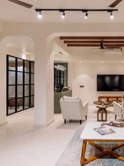A wide view of the open-plan living and lounge area in 'Project Lily', showing the seamless flow between different zones, unified by an earthy color palette and modern furniture.