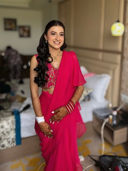 Dipped in hues of pink for her mehndi ceremony. This look is bright, happy, and perfect for a day of celebration.