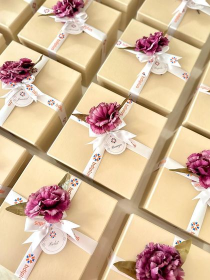 For a corporate Diwali order with BDI Plus, we designed these sophisticated gift boxes. Each one was finished with a custom-branded ribbon and a floral accent, creating a warm and festive gift for their team members.