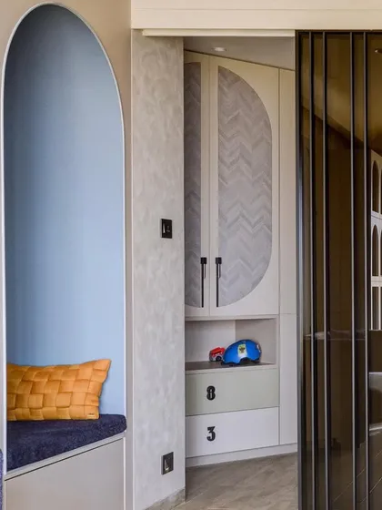 A cozy reading nook built into the corner of a kid's room. The arched design and cushioned seating create a perfect little hideaway for reading and quiet time.