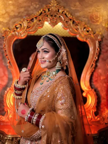 A profile shot of the bride against an ornate mirror, using warm backlighting to create a royal glow.