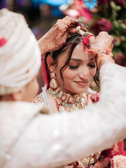 A sacred moment during the wedding ceremony. The bride's makeup is soft and emotional, designed to look beautiful even through happy tears.