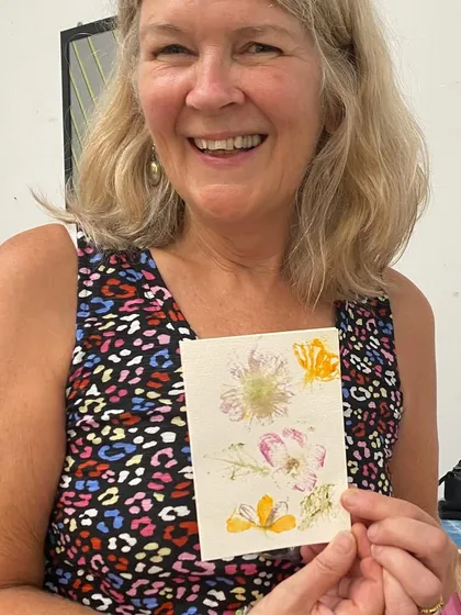 The joy of creating something beautiful with your own hands. This participant is delighted with her floral greeting card, a perfect example of the unique botanical art you can make in my workshops.