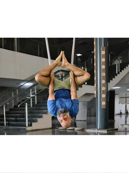 Our instructor demonstrates an advanced inverted binding pose, showing the level of body control and flexibility that can be achieved with consistent practice.
