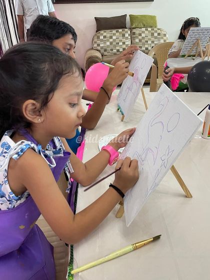 The first few strokes on a blank canvas are always the most exciting. This young artist is carefully outlining her flamingo design before bringing it to life with color.