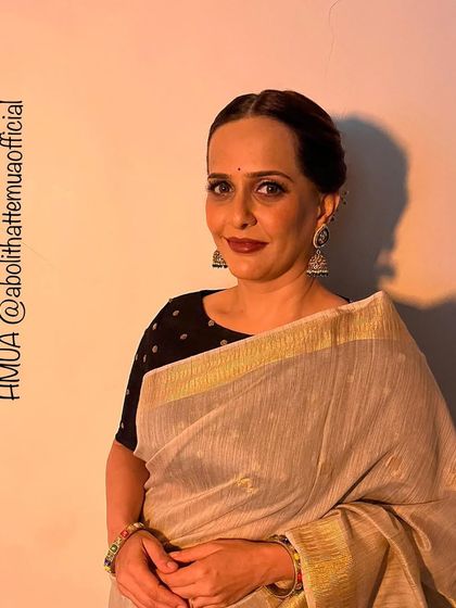 An elegant party look for Rashmi. The makeup is sophisticated, with a bold lip and defined eyes, perfect for an evening event.