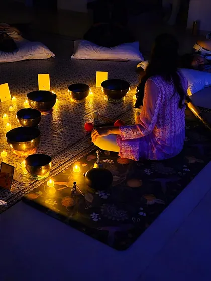 This is what my group sound bath sessions look like. Participants lie back and let the resonant frequencies of the singing bowls wash over them, melting away tension in a candlelit, tranquil environment.