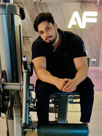 Taking a moment to rest on a leg extension machine at the gym.