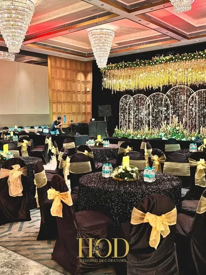 The celebration continues long after the vows. I design complete reception spaces, like this glamorous black and gold themed dining area, ensuring the decor, from the stage to the seating, is cohesive, elegant, and comfortable for your guests.