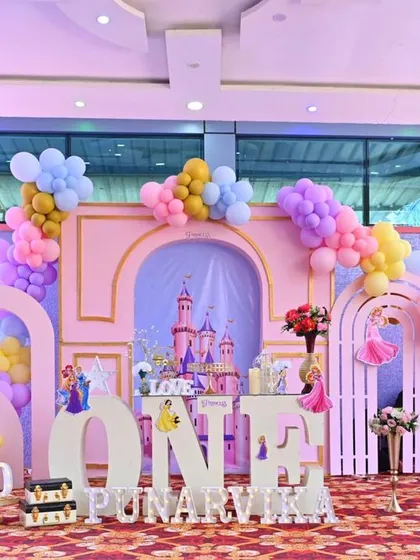 A fairytale first birthday fit for a little princess. We built a complete castle scene with multiple backdrops, character cutouts, and dreamy pastel balloon arches to bring this magical Disney theme to life for Punarvika.
