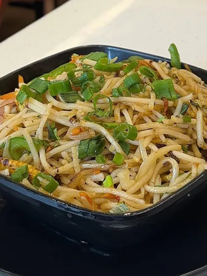 A bowl of my freshly prepared Hakka Noodles, garnished with spring onions. It's a light and healthy option that's full of flavour.