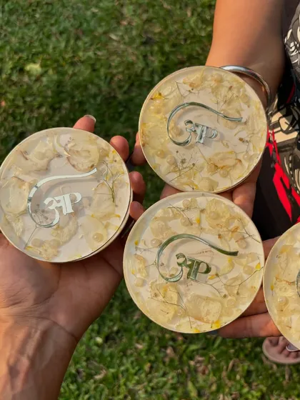 A set of four custom coasters, each preserving delicate white flowers and a personalized logo. These make for great corporate or personal gifts.