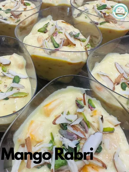 My seasonal Mango Rabri is a delightful fusion dessert. It's a traditional, creamy Indian rabri infused with fresh mango pulp and garnished with sliced almonds and pistachios.