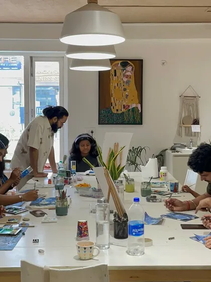 A full house at the studio with everyone focused on their paintings. Our large central table is the heart of our space, where creators of all ages come together.