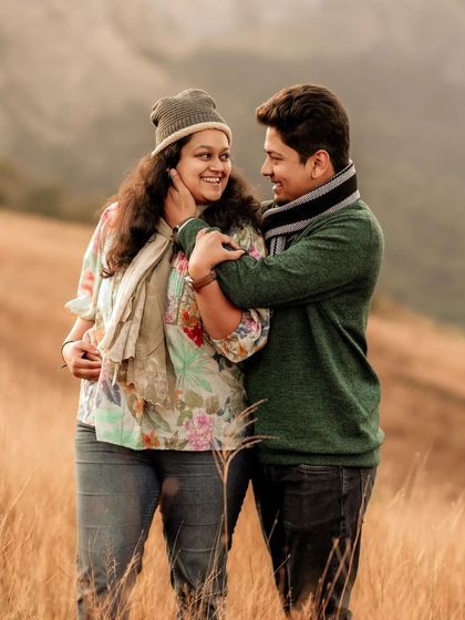 Dressed in cozy winter wear, this couple shares a look of love amidst a field of golden grass. My sessions are relaxed, allowing for natural interactions like this that truly reflect the connection between two people.