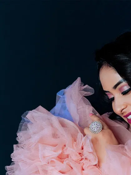 An artistic, cropped portrait that focuses on the details. The composition draws attention to the model's expression, makeup, and the intricate ring, showing my eye for detail in glamour photography.