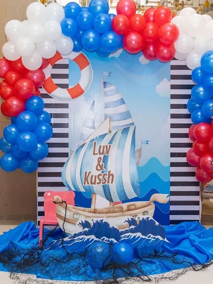 For the 'sea' portion of our travel theme, I created this nautical photo booth. The 'L&K Cruise' sign, anchor, and lifebuoy props made for some adorable pictures.