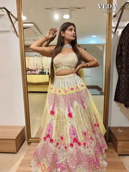 A full-length mirror shot showing off the bright colors and playful design of this party lehenga.