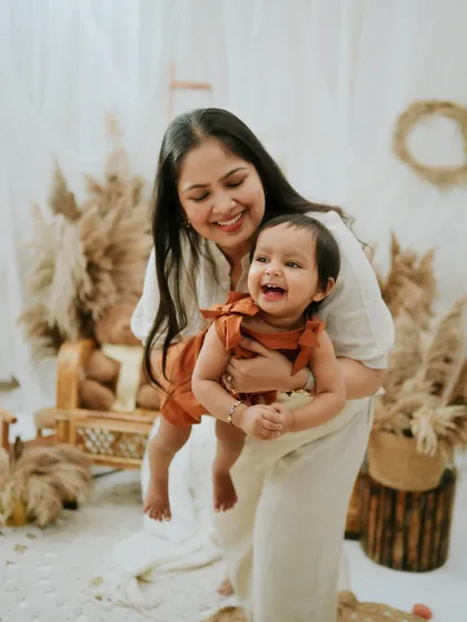 A mother's joy as she plays with her daughter. Her laughter is infectious in this beautiful, candid shot.
