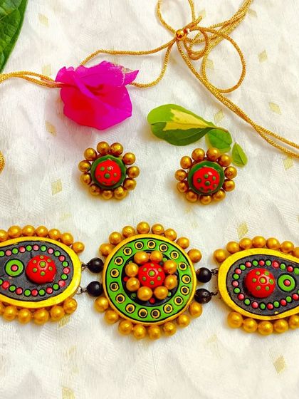 The same paisley and mandala choker design, here in a festive green, yellow, and red palette.