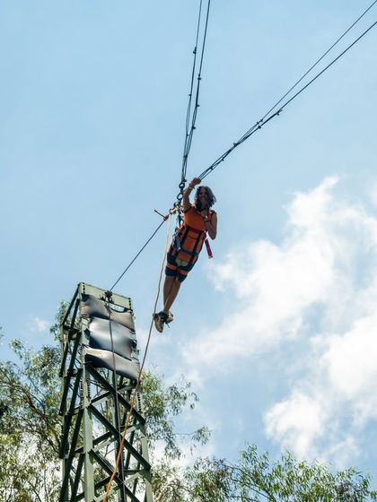 A participant hangs on at the very top of the Rocket Ejector, just before the thrilling drop.