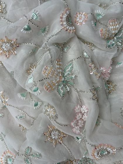 This image captures the beautiful drape of my embroidered georgette. The pastel floral embroidery with silver thread and sequins creates a dreamy, ethereal quality perfect for a special occasion gown.