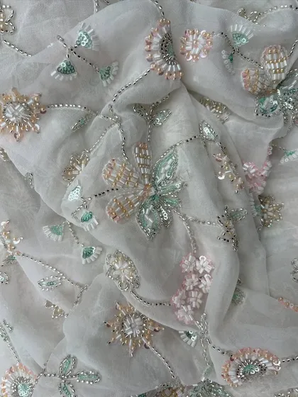 This image captures the beautiful drape of my embroidered georgette. The pastel floral embroidery with silver thread and sequins creates a dreamy, ethereal quality perfect for a special occasion gown.