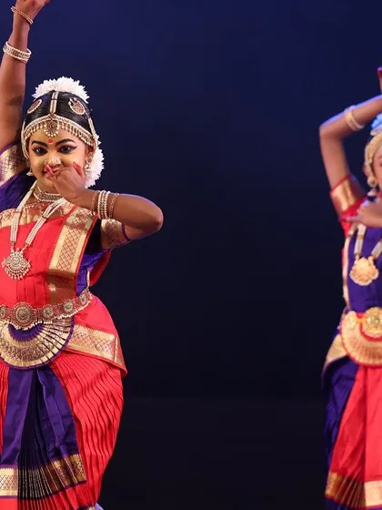 A duet performance by two of my students, their arms extended in a beautiful, coordinated pose that speaks of harmony and partnership in dance.
