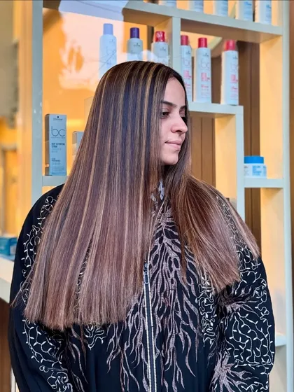 Golden Blonde highlights on straight, sleek hair. This creates a striking, high-contrast look that is bold and beautiful.