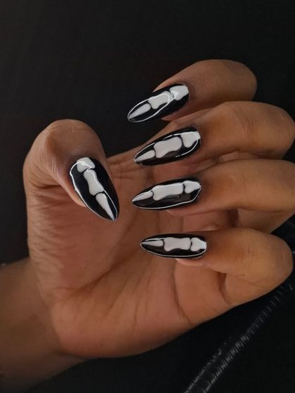A side view of the spooky skeleton nails, showing how the design wraps around the nail for a more realistic and impactful effect.
