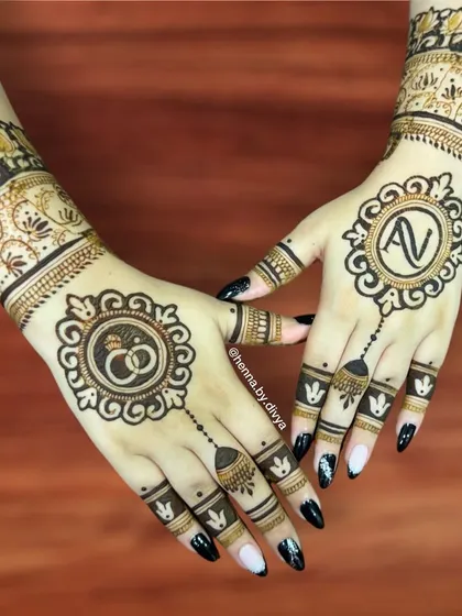 Personalized mehendi is a wonderful way to celebrate a union. This engagement design features the couple's initials and a ring motif, making it extra special for the occasion.