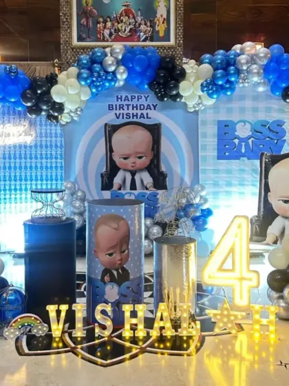 A complete Boss Baby setup for Vishal's 4th birthday, featuring multiple character cutouts and a detailed, themed stage.