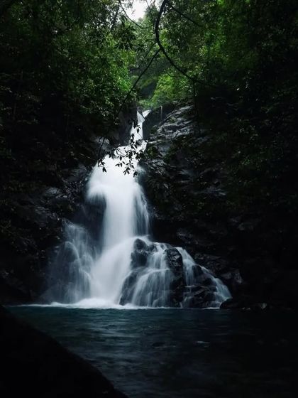 The serene beauty of a secluded waterfall in North Canara, captured in low light. These are the peaceful moments we seek on our offbeat treks.