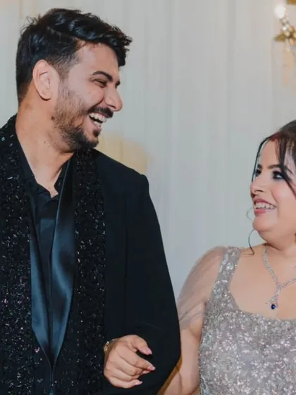 A moment of shared laughter between the couple on their reception stage, capturing the joy of the evening.
