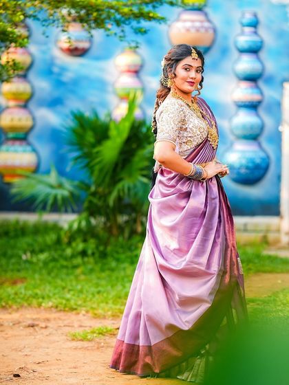 A beautiful lavender and purple half saree, perfect for a portfolio shoot or a special event. The way the davani is draped gives it a modern, stylish look while staying true to its traditional roots.