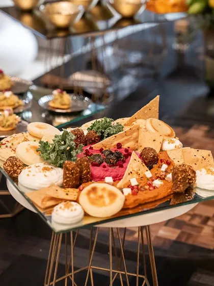 A close-up of a Mediterranean platter from the Casa Mia event, with hummus, pita, and other delicious bites.