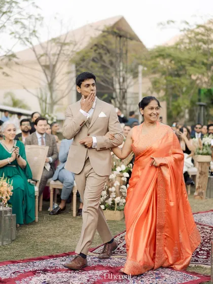 The groom's emotional entrance with his mother, his hand to his mouth in awe and anticipation. This is a raw, beautiful moment that shows the deep emotions of the day.