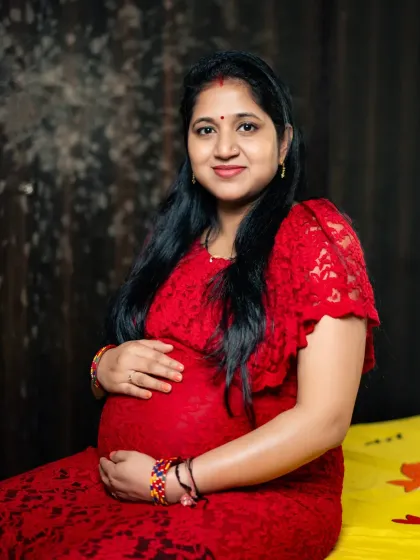 A lovely seated portrait of a mom to be, showcasing her beautiful baby bump. This was taken during a comfortable and relaxed indoor session.