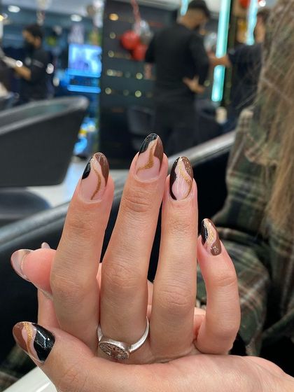 A chic and modern design with abstract swirls in brown and black tones over a neutral base, creating a sophisticated, artistic look.