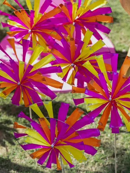 A close-up of the colorful pinwheels, showing their vibrant, layered paper construction.