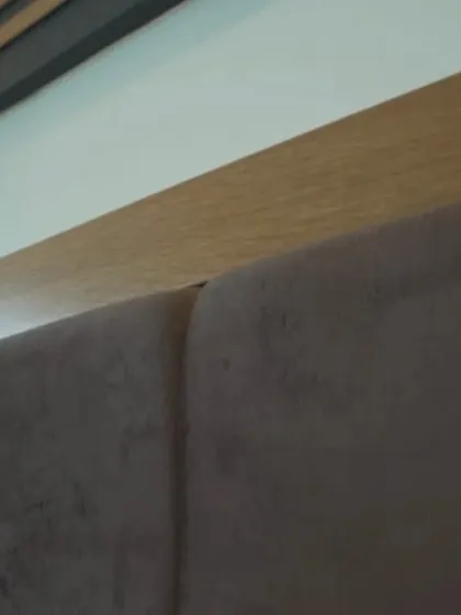Quality is in the details. This close-up shows the fine craftsmanship of our modular beds, highlighting the seamless joinery between the veneer frame and the plush leatherette headboard.
