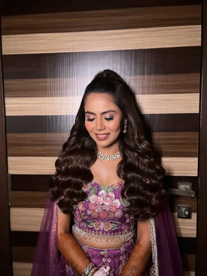A still shot of the gorgeous Sangeet look. The half-up style gives volume at the crown while the waves add length and drama.