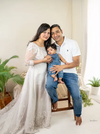 A sweet and simple portrait of new parents with their baby. The focus is entirely on their new family and the love that surrounds them.