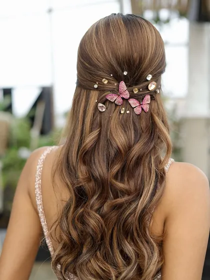 Hair is an art form. For this look, I created soft waves and adorned them with these delicate butterfly and crystal accessories, adding a touch of whimsy and romance perfect for a sangeet or reception.