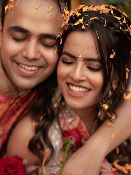 A sweet, candid moment of the couple during the Haldi ceremony, her makeup looking fresh and natural.